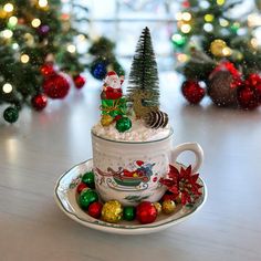 a cup filled with snow and christmas decorations