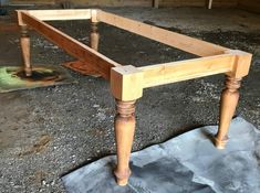 a wooden table sitting on top of a piece of paper next to a chair leg