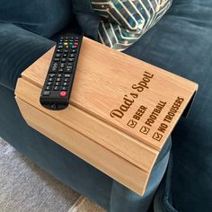 a remote control sitting on top of a wooden box that says do you want something?