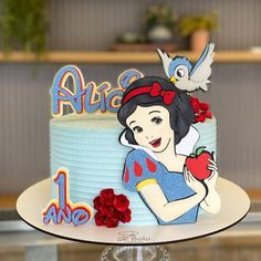 there is a cake that has an image of snow white on it and red roses