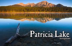 a lake with mountains in the background and text that reads patricaa lake bungalows