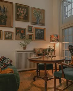 a living room filled with furniture and pictures on the wall