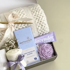 a gift box filled with baby items including diapers and blankets