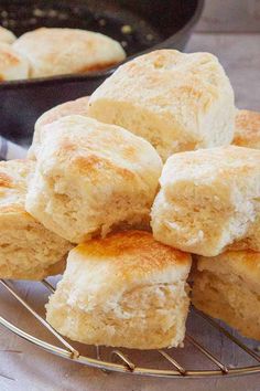 biscuits cooling on a wire rack in front of a skillet with one piece cut out