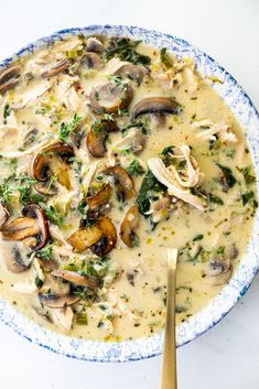 a blue and white bowl filled with mushroom soup