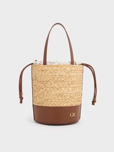 Luxury Beige Bucket Bag With Intrecciato Weave, Luxury Leather Basket Bucket Bag, Luxury Woven Leather Straw Bucket Bag, Luxury Straw Bucket Bag With Woven Leather, Chic Leather Bucket Straw Bag, Brown Straw Bag With Intrecciato Weave, Beige Bucket Bag With Intrecciato Weave, Elegant Leather Bucket Straw Bag, Luxury Straw Basket Bag With Braided Handles