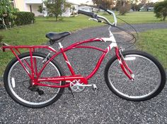 a red bicycle parked on the side of a road