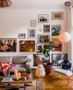 a living room filled with furniture and pictures on the wall