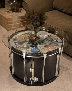 a glass table topped with magazines and a peacock figurine sitting on top of it