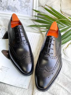 Exude timeless elegance with these Black Wingtip Oxford shoes. Crafted from premium cowskin leather, these brogues feature intricate perforations and pinking, adding a touch of sophistication to any formal ensemble. The comfortable nubuck lining and durable rubber sole ensure a confident stride, making them perfect for business meetings and special occasions like weddings. Wingtip Leather Shoes With Leather Sole For Galas, Elegant Leather Lace-up Shoes With Perforations, Business Lace-up Shoes With Perforations And Round Toe, Classic Leather Shoes With Perforated Almond Toe, Business Oxfords With Perforations And Round Toe, Leather Oxfords With Perforations For Business, Elegant Leather Oxfords With Perforations, Business Leather Oxfords With Perforations, Business Leather Lace-up Shoes With Perforations