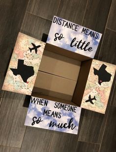 three boxes with different signs on them sitting on a wooden floor next to each other