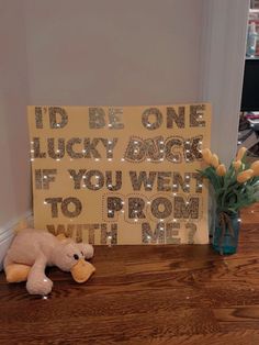 a teddy bear sitting next to a sign that says i'd be one lucky angel if you went to prom with me