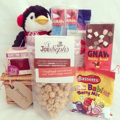 a stuffed penguin sitting next to some snacks