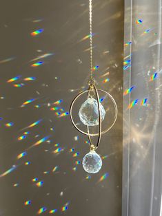 the sun shines brightly in front of a window with an object hanging from it's side