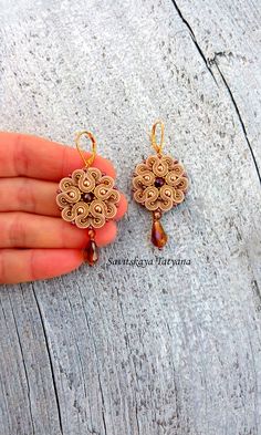 The elegant gold beige soutache earrings will perfectly accentuate your look. They will complement your everyday outfits and evening gowns.       Soutache earrings are very light! And it is their great benefit! You will not feel them in your earlaps despite their big size!      The earrings are made in soutache technique using a soutache cord, glass and crystal beads. The fixture is rhodium-plated and will not cause allergy.      If you would like to have these earrings in a different color, send me a personal message and we will talk it through. A bracelet or a necklace can also be made to complement these earrings. Feel free to contact me and we will discuss your wishes and requests.      See the other jewelry from my store. https://www.etsy.com/shop/MagicalSoutache Thank you for your in Beige Jewelry, Round Flowers, Earrings Boho Chic, Flowers Earrings, Soutache Necklace, Soutache Earrings, Soutache Jewelry, Jewelry Statement, Jewelry Outfit