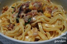 a white bowl filled with pasta and meat