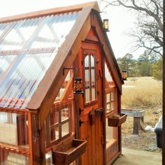 a small wooden house with a metal roof