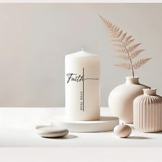 two white vases, one with a plant and the other with a candle