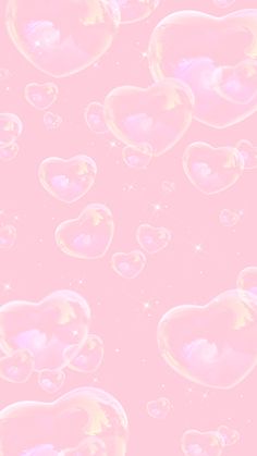 soap bubbles floating in the air on a pink background