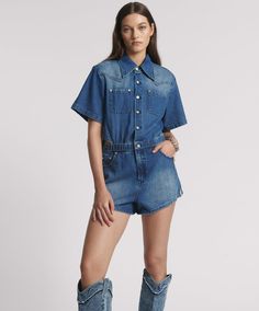 Get ready to roll in the ROSEWOOD BLUE TAYLOR JUMPSUIT. ROSEWOOD BLUE is a perfect deep mid-blue denim wash with contrast tobacco top-stitching. Complete with interior floral print - visible when the underside is shown. Elegant and sexy contemporary-styled denim jumpsuit/playsuit. Comfy elasticated waist to cinch you in. Western-style short sleeved shirt in the top. Flippy flattering curved hem shorts in the bottom. Two front squared chest patch pockets and internal side pockets. Classic yo Blue Relaxed Fit Button-up Denim Jumpsuit, Mid-rise Denim Blue Cotton Jumpsuit, Short-sleeve Denim Jumpsuit With Pockets, High-rise Cotton Denim Jumpsuit With Button Closure, High-waist Medium Wash Denim Jumpsuit With Button Closure, Low Waist Skirt, Jumpsuit Online, Flare Leg Jeans, Midi Maxi Dress