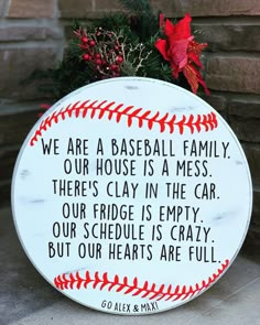 a baseball themed sign with the words we are a baseball family, our house is a mess, there's clay in the car