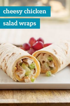 chicken salad wraps on a plate with grapes