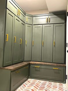 an empty kitchen with green cabinets and yellow knobs on the cupboards in the corner