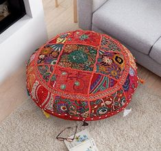 a colorful patchwork ottoman sits on the floor