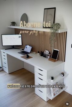 an office desk with two computers on it