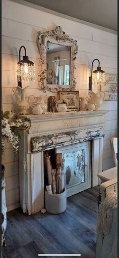 a room with a fireplace, mirror and vases on the mantle next to it