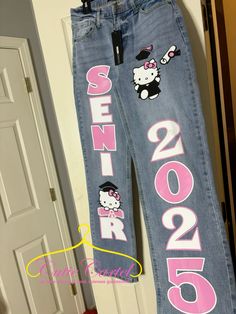 @cutie.cartel on ig , custom jeans #senior #seniorpictureideas #pants #seniorpants #hellokitty Cute Senior Pants Ideas, Custom Senior Jeans, Senior Pants Hello Kitty, Senior Bookbag Ideas, Senior 25, Jean Senior Painting