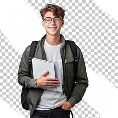 a young man holding a book and smiling at the camera with his hands in his pockets