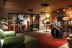 a living room filled with furniture and musical instruments