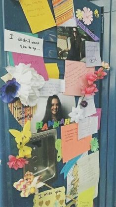 the door is decorated with many different pictures and words on it, including paper flowers