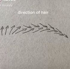 an arrow drawn on top of a piece of paper with the words direction of hair