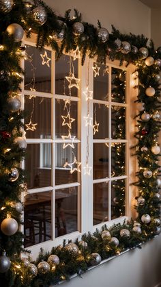 a window decorated with christmas lights and garland