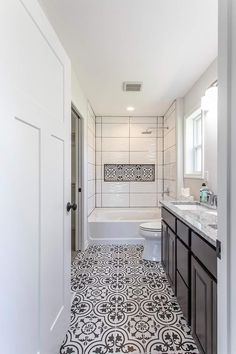 a bathroom with black and white tile flooring