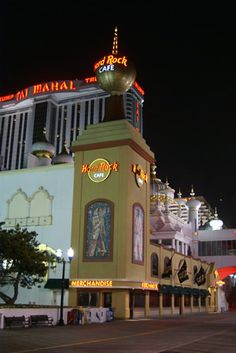 the las vegas hotel and casino is lit up at night with neon lights on it