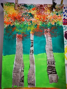 an art project made out of newspaper strips with trees in the middle and colorful background