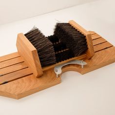 a brush is sitting on top of a wooden holder