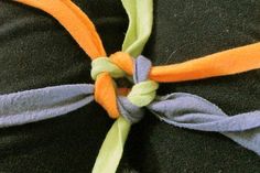 an orange and blue knot tied to a black blanket