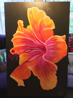 an orange and pink flower painted on a black canvas