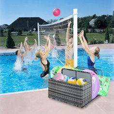 two women are playing volleyball in the pool while another woman jumps up to catch it