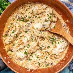 a pan filled with chicken and mushrooms covered in gravy