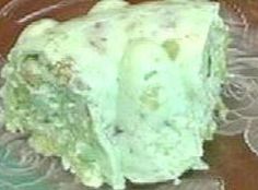 a piece of cake sitting on top of a glass plate covered in green frosting