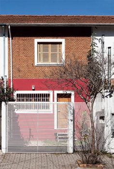 a red and white house with an iron gate