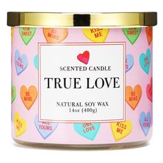 a pink candle with hearts on it and the words true love written in gold lettering