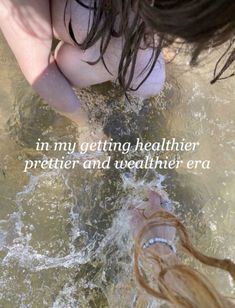 a woman is standing in the water with her hand on her hip and an inscription that reads, i'm my getting healthier prettier and weather era