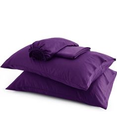 two purple pillows on top of each other and one has a flower in the middle