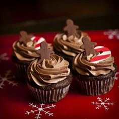 three cupcakes with chocolate frosting on a red plate